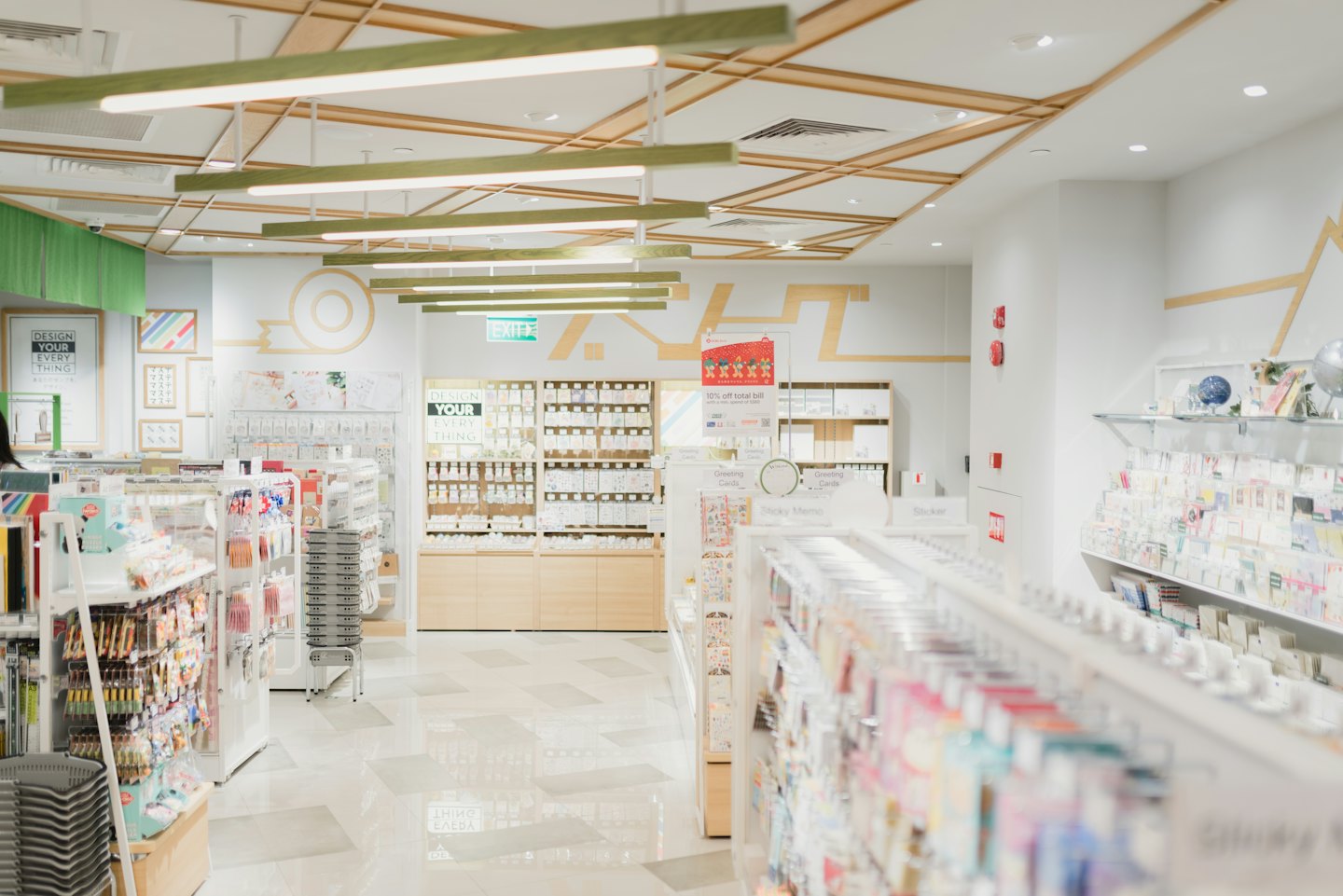 Modern stationery shop with aisles of colorful merchandise.